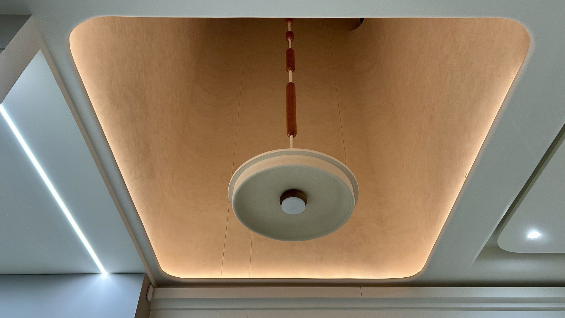 wooden custom light installation at double height