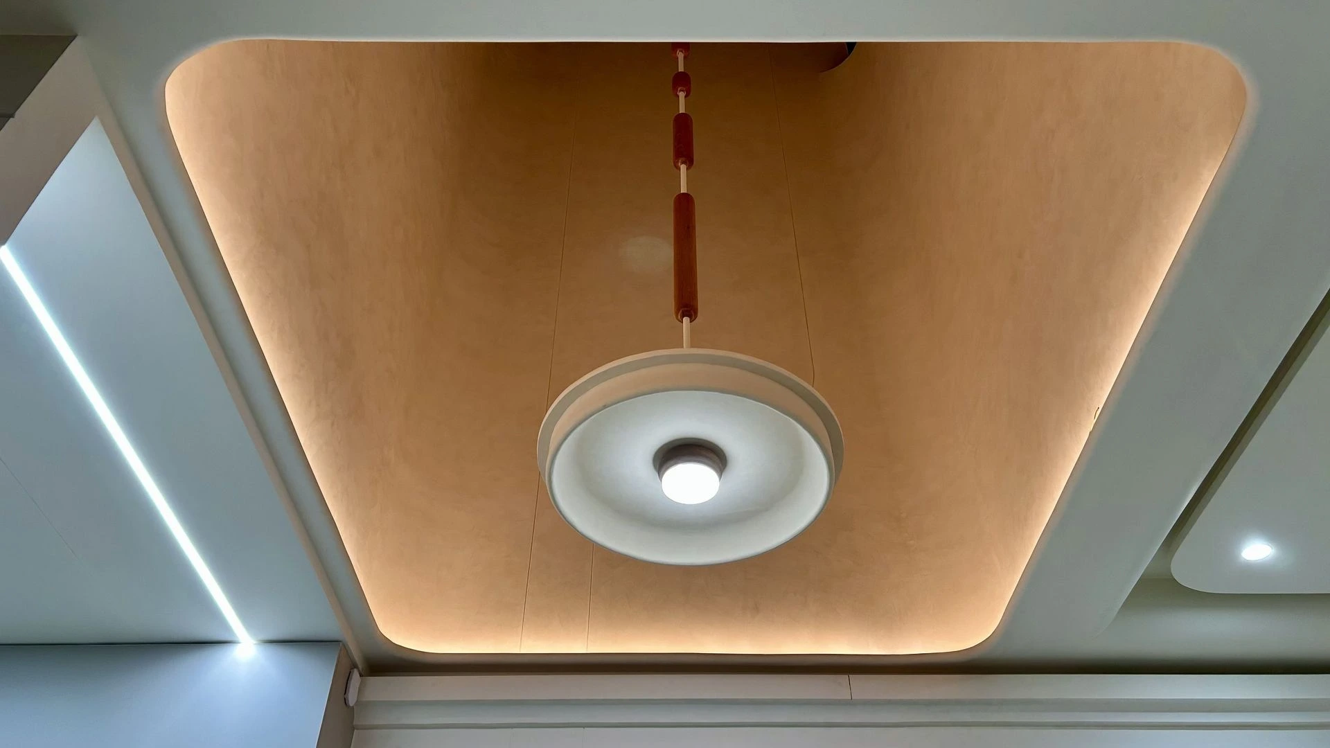 wooden custom light installation at double height