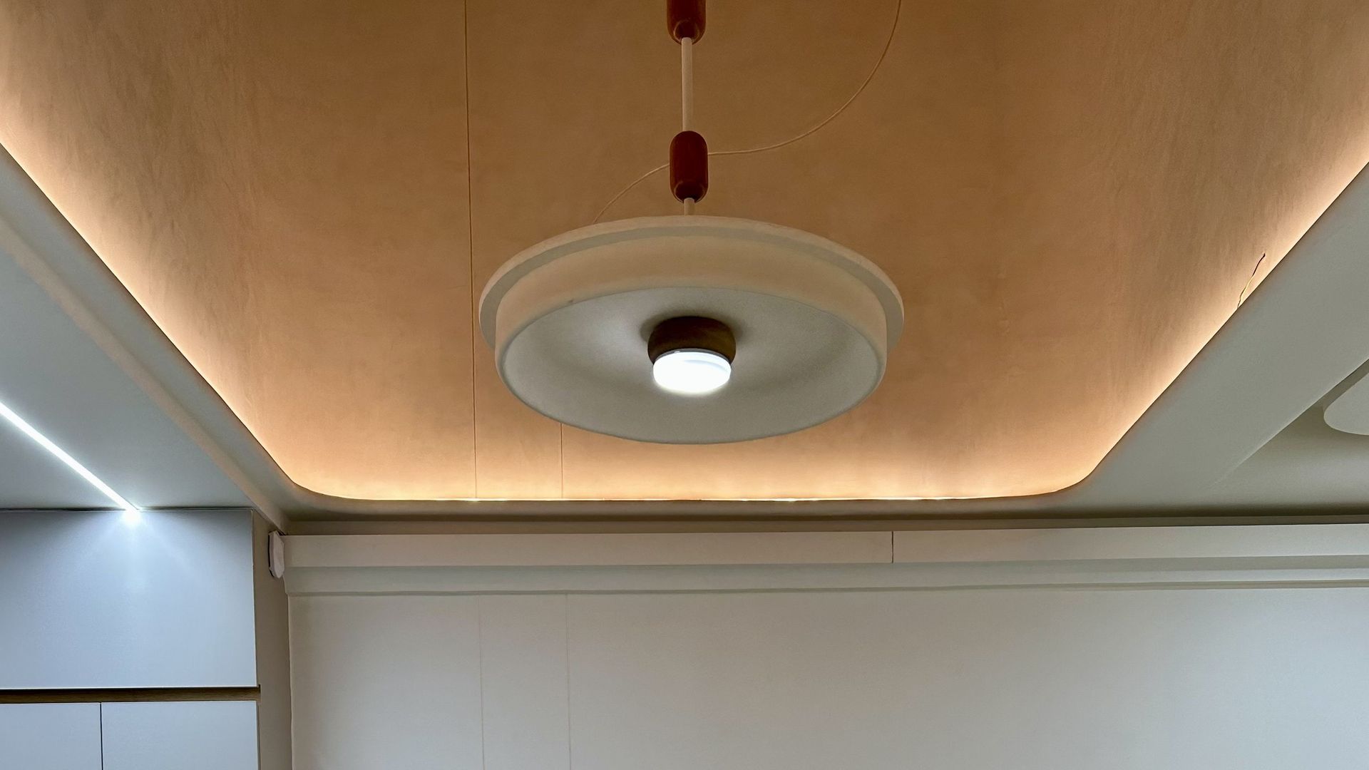 wooden custom light installation at double height